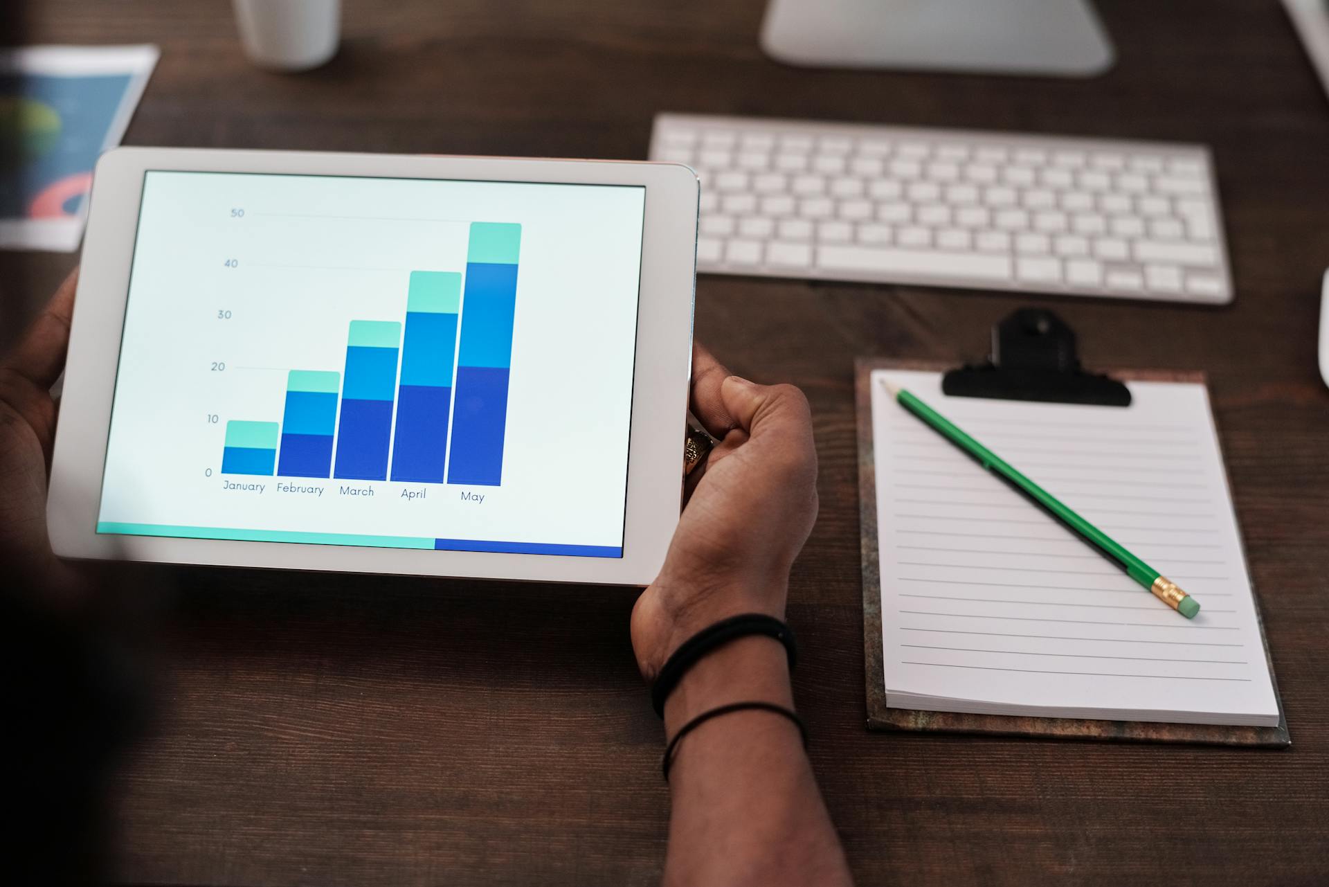 a man showing a graph on tablet